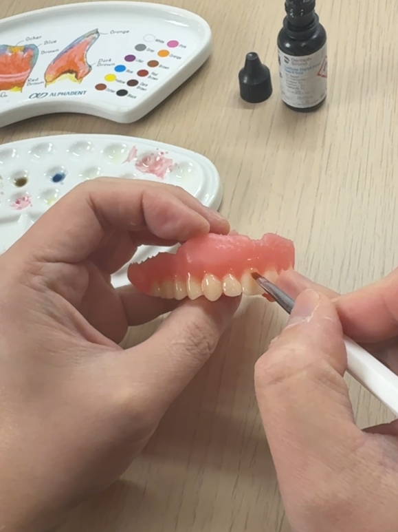 Denture teeth being detailed by hand in the laboratory
